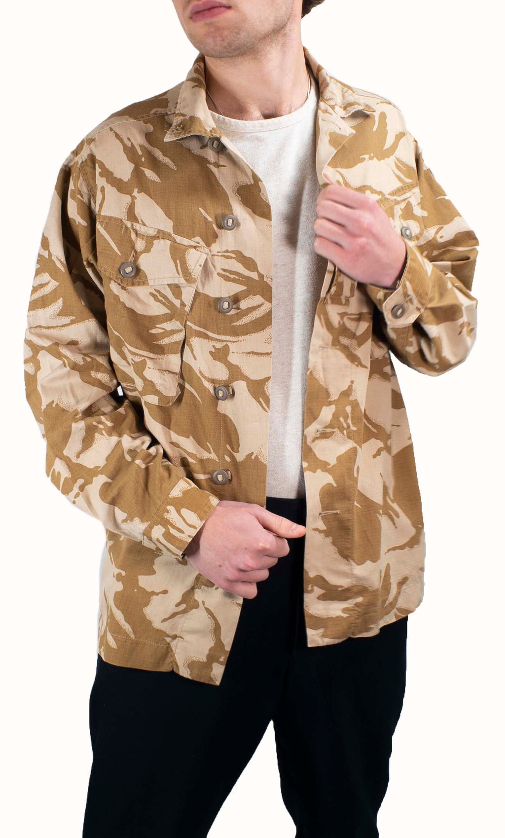 Model wearing a British Desert Combat Shirt in two-tone DPM camouflage with Canadian-style buttons and chest pockets.