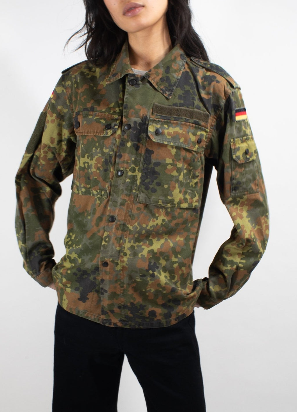 Front close-up of women's Bundeswehr Flecktarn field shirt with tactical chest pockets, hook-and-loop utility space, and durable cotton-polyester blend.