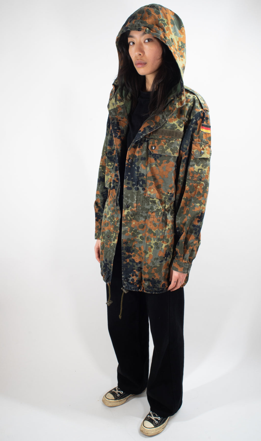 Front view of the German Army Flecktarn Parka with the hood up for added cold-weather protection.