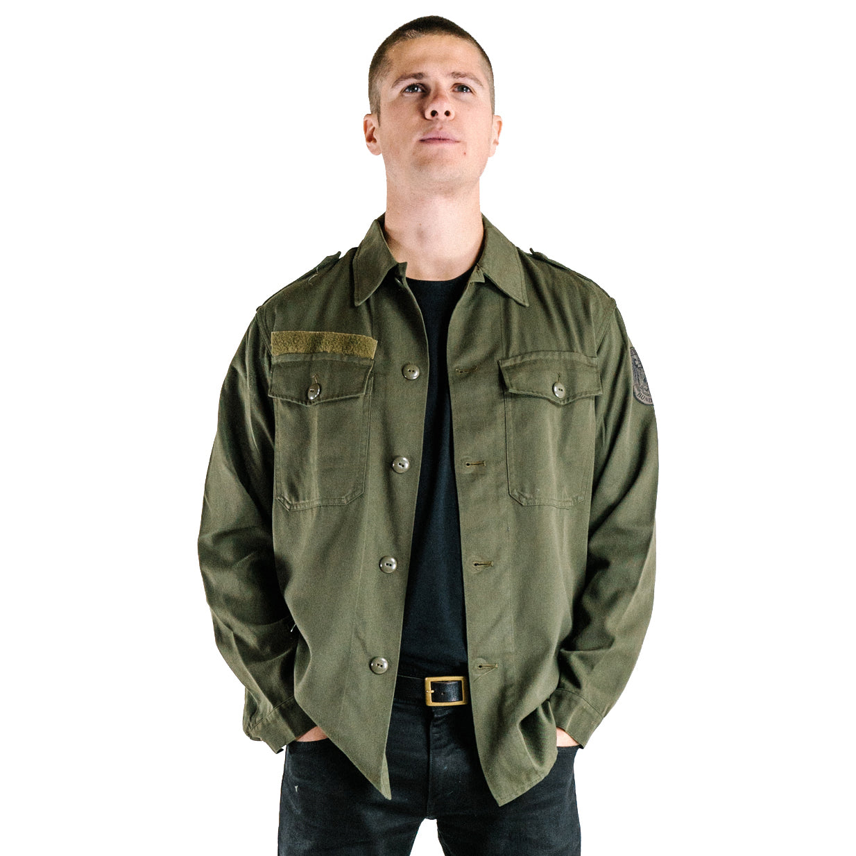 A model wearing the authentic Austrian army olive combat shirt, showcasing the shirt's fit, button-down front, and rugged material.