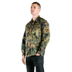 Man wearing a vintage German army flecktarn camo shirt with buttoned front, chest pockets, and German flag sleeve insignia.