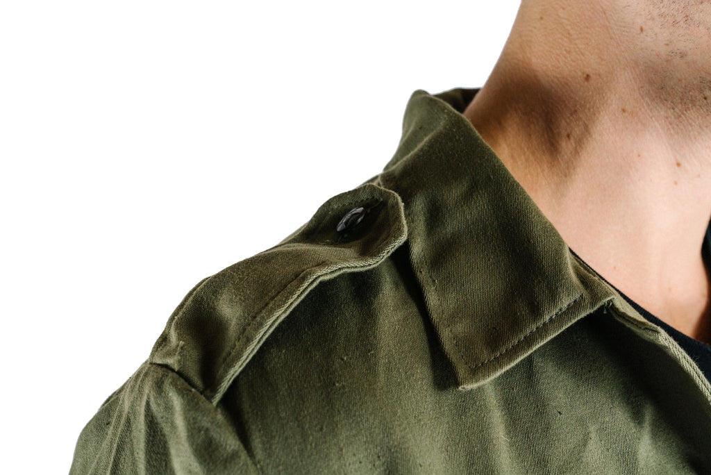 Close-up of the shoulder epaulette on an authentic Bulgarian olive green military fatigue shirt.