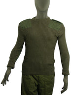 Front view of an olive green British Army Woolly Pully jumper featuring heavy ribbing, polycotton shoulder patches, and epaulettes on a mannequin.