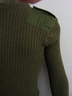 Close-up of the shoulder detail on a genuine British Army ribbed wool jumper, highlighting the durable military polycotton epaulette and stitch work.