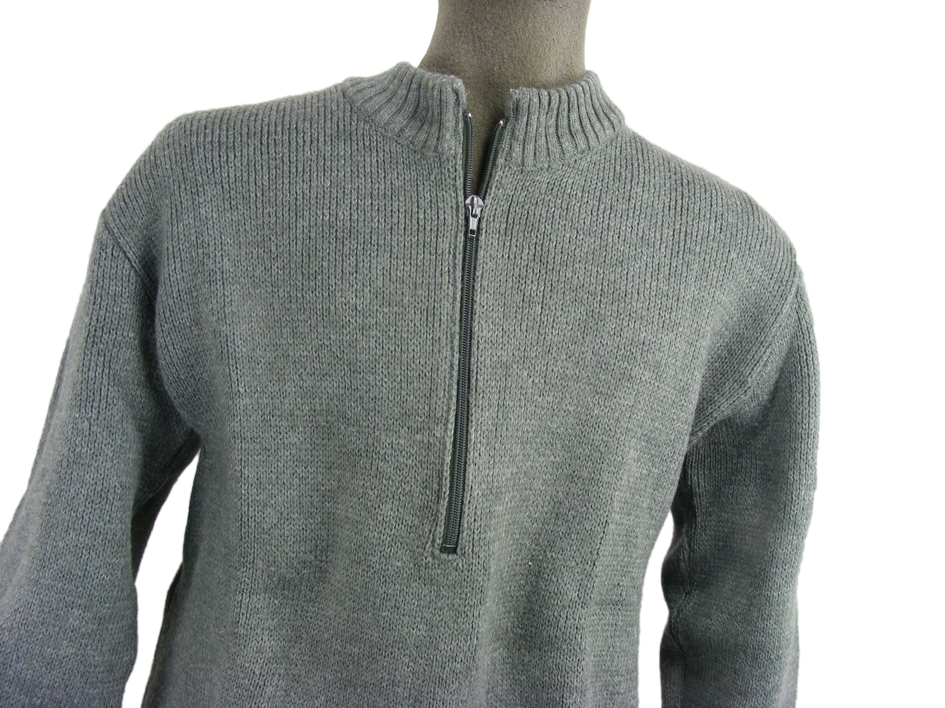 Close-up of a grey Swiss military-style wool sweater on a mannequin, highlighting the heavy knit and central zip-neck feature.