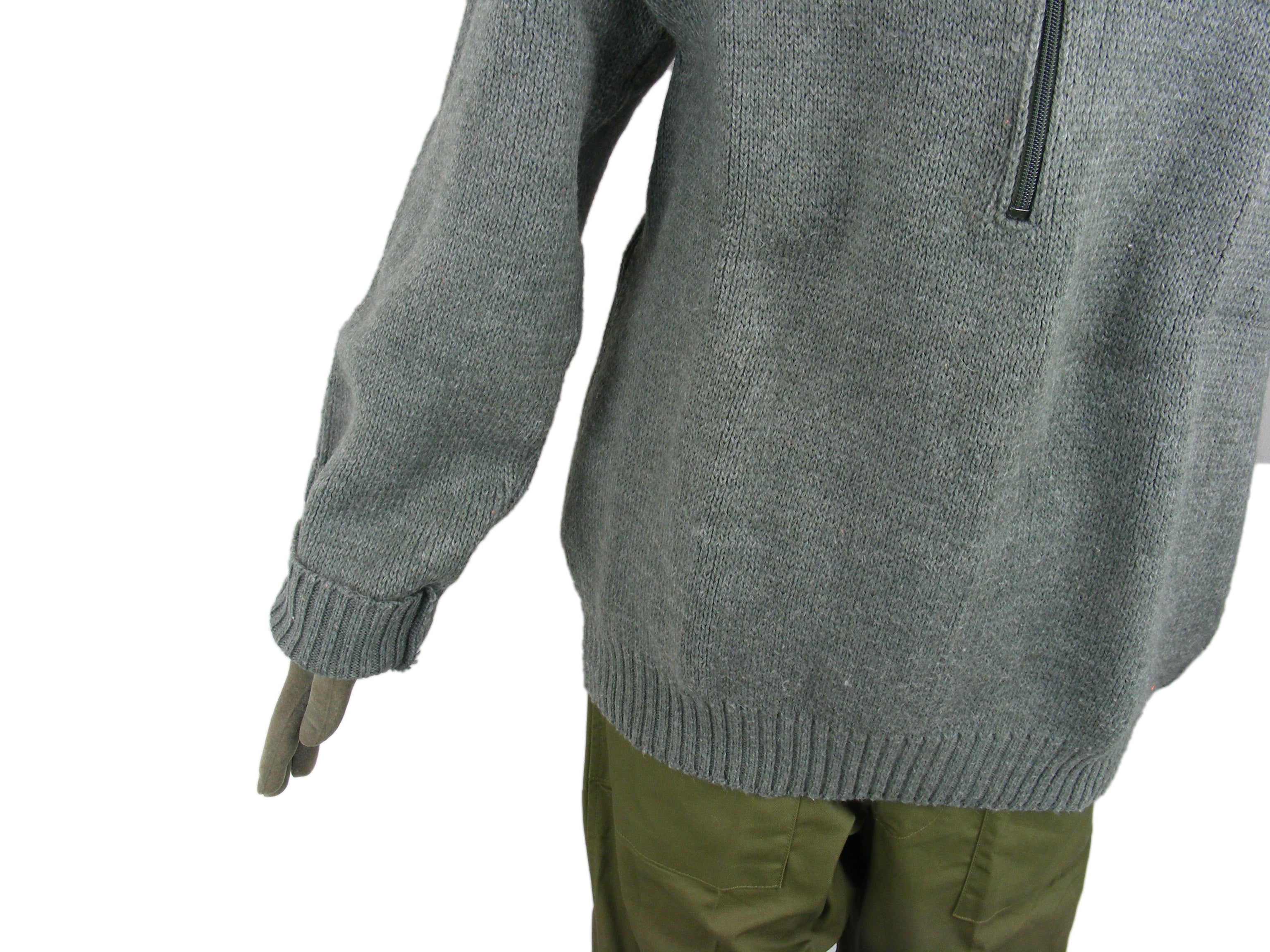 Side view of a grey Swiss Army wool jumper, focusing on the sleeve texture and ribbed waistband on a mannequin.
