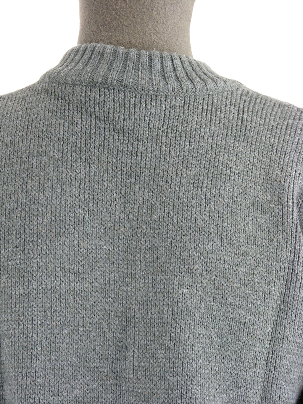 Macro detail of the high-quality grey wool knit and rib-knit neckline of the Swiss Army sweater.