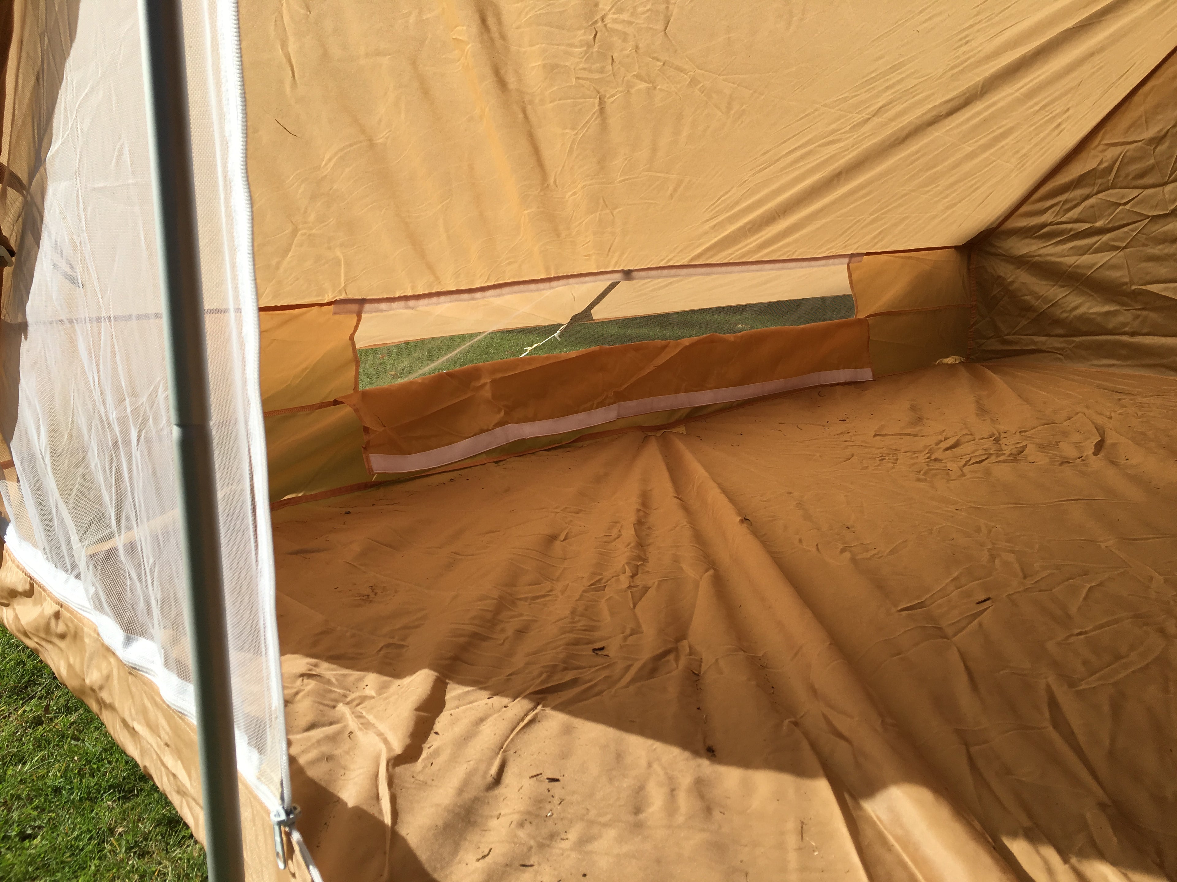 View of the open side wall ventilation mesh panel with the Velcro-secured flap folded down.