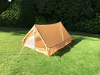 Exterior side angle of the military tent, showing the ventilation mesh strip along the wall.