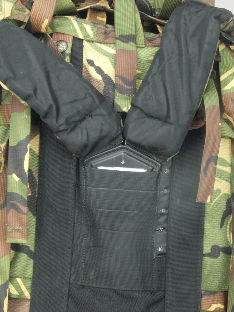 Close-up of the rear harness system on the Dutch army rucksack, showing padded shoulder straps and an identification pouch.