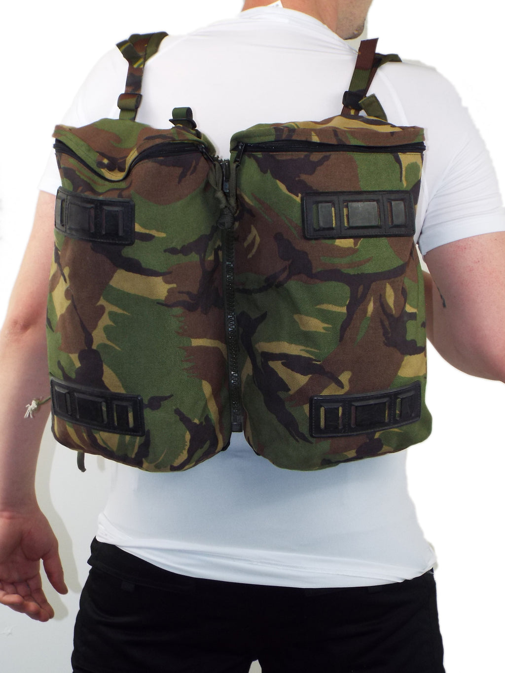 Person wearing a Dutch Woodland camo day pack made of two joined side pockets from a rucksack.