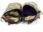Two Dutch Woodland camo rucksack side pockets partially unzipped, showing interior storage capacity.