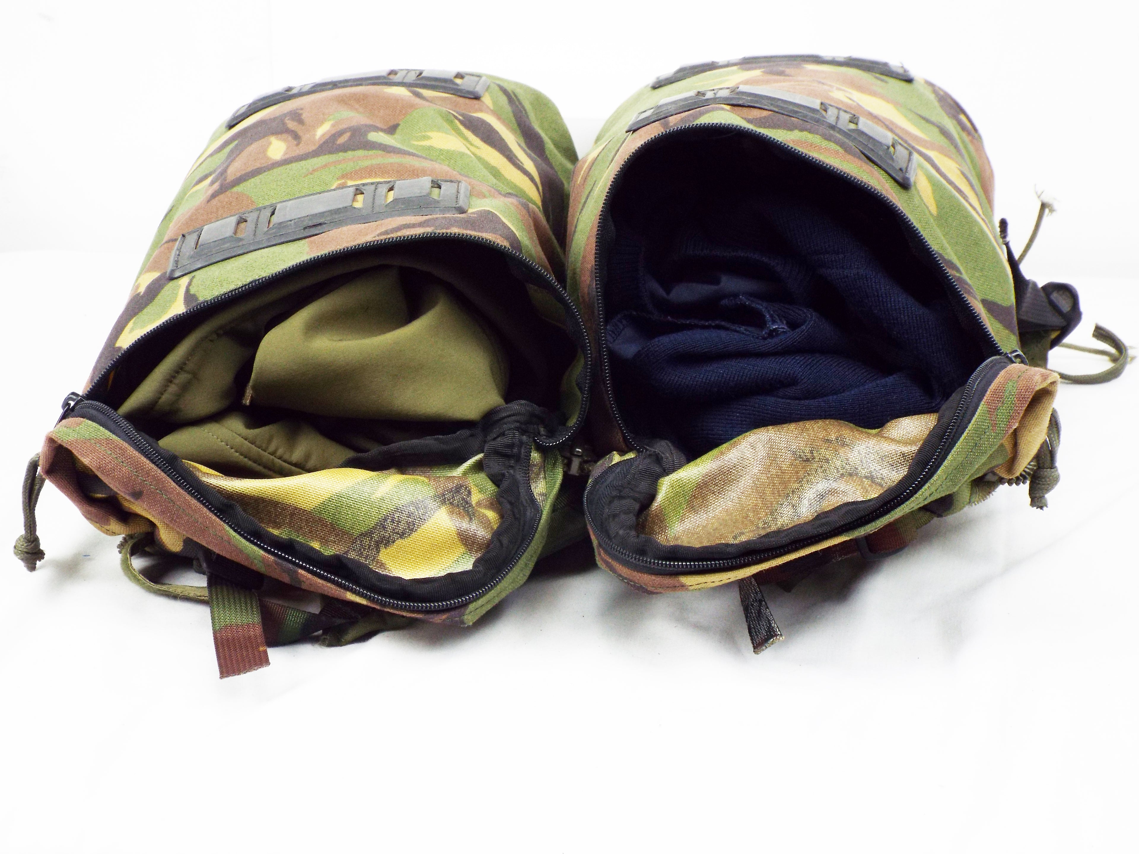 Two Dutch Woodland camo rucksack side pockets partially unzipped, showing interior storage capacity.