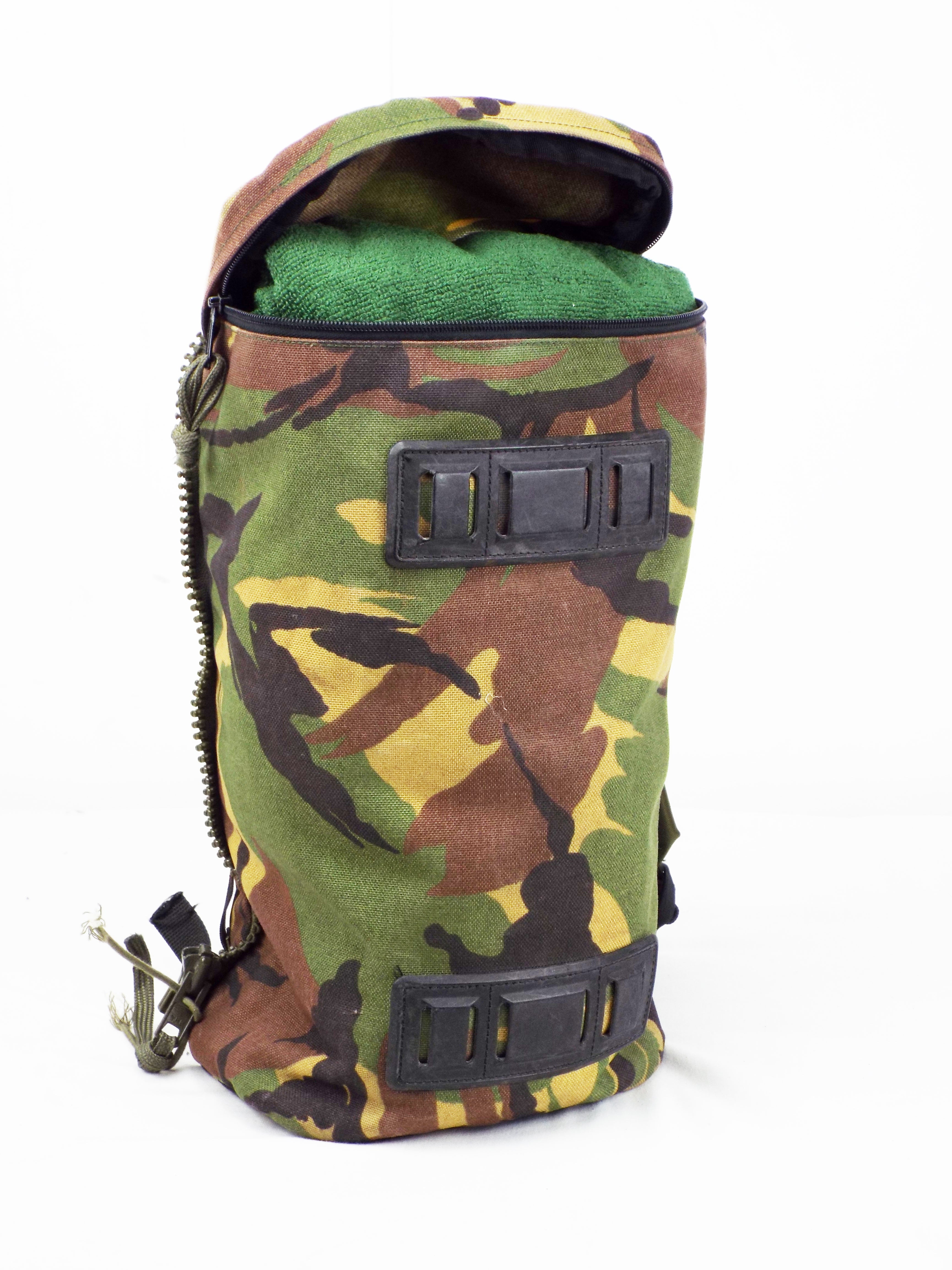 Top view of a single Dutch military camo side pocket with its zipped lid partially open, displaying internal contents.