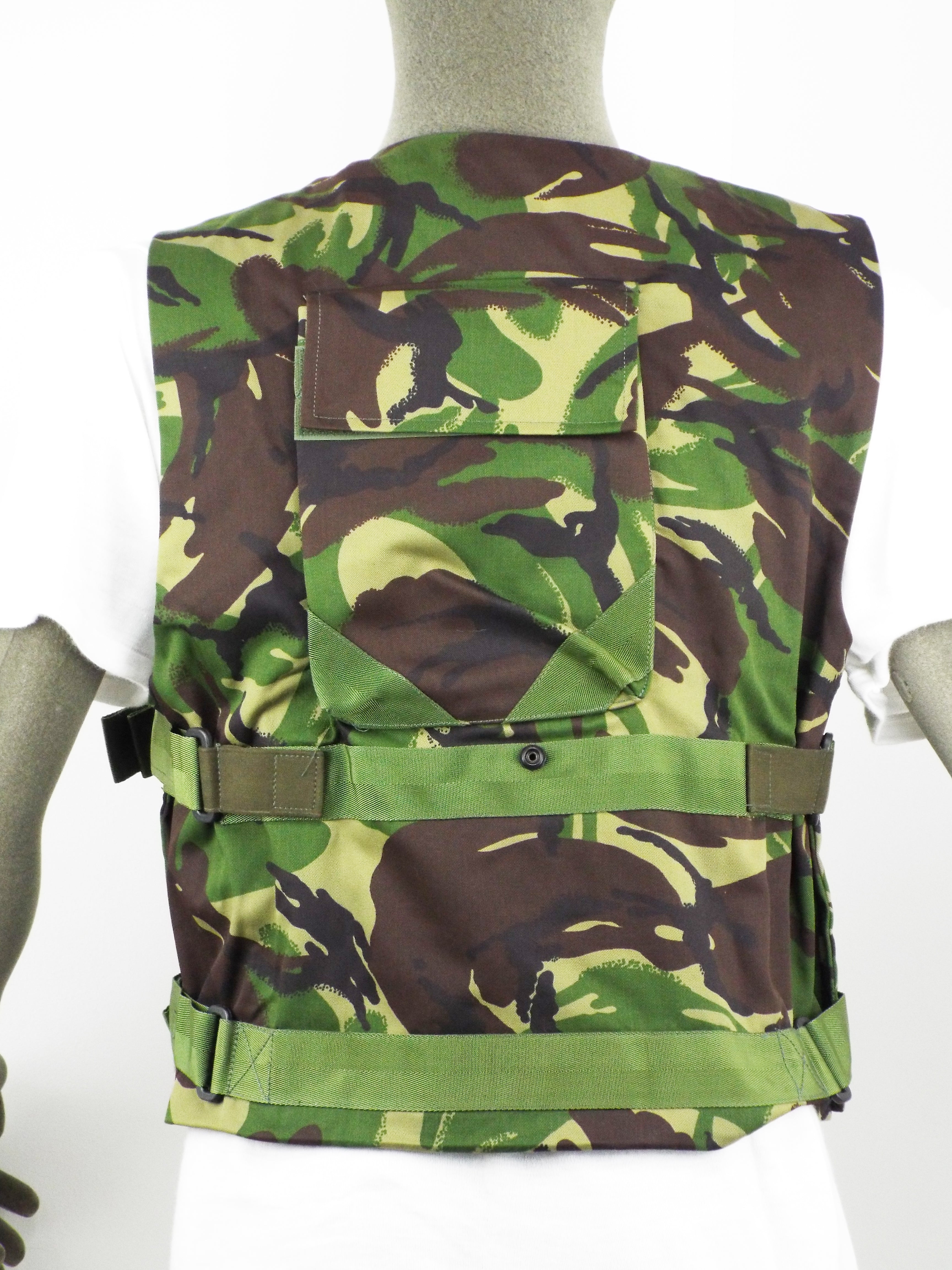 Rear view of the British DPM woodland camo protective vest showing the back pocket, webbing straps, and secure popper stud fasteners.