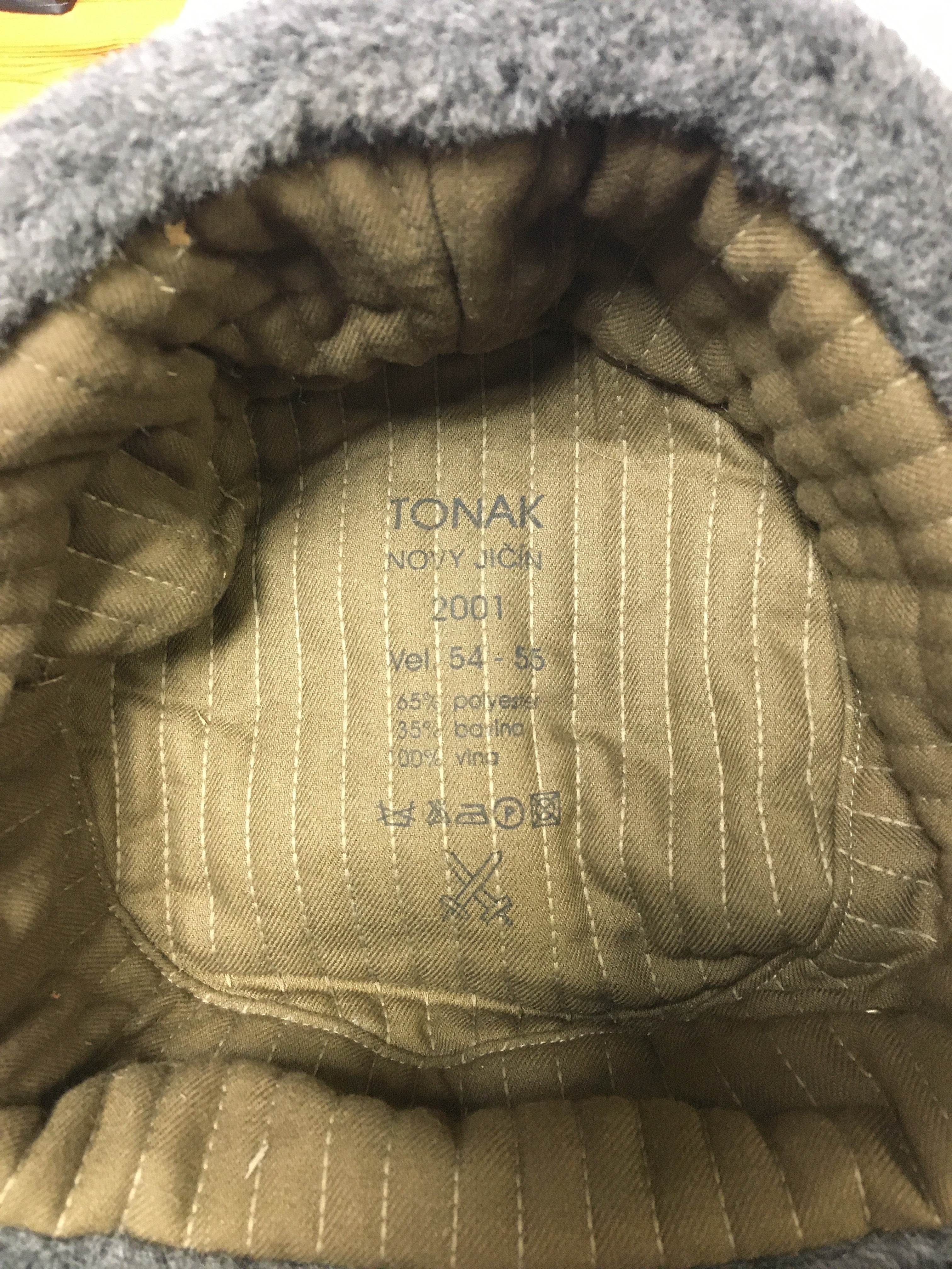 Interior of the Czech Ushanka hat showing the Tonak maker stamp, size 54-55, and quilted cotton-polyester lining details.