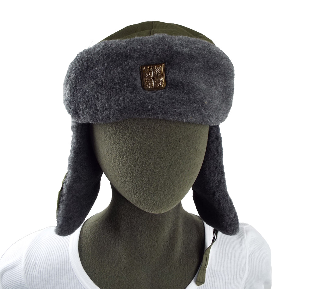 Front view of a Czech Ushanka winter hat on a mannequin, featuring ear flaps and a small metallic shield badge.