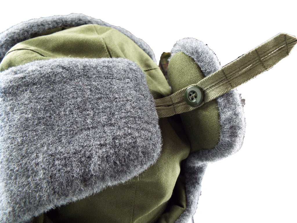Close-up detail of the side button fastener used to secure the synthetic fur ear flaps of the Czech Army winter hat.