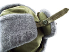 Close-up detail of the side button fastener used to secure the synthetic fur ear flaps of the Czech Army winter hat.