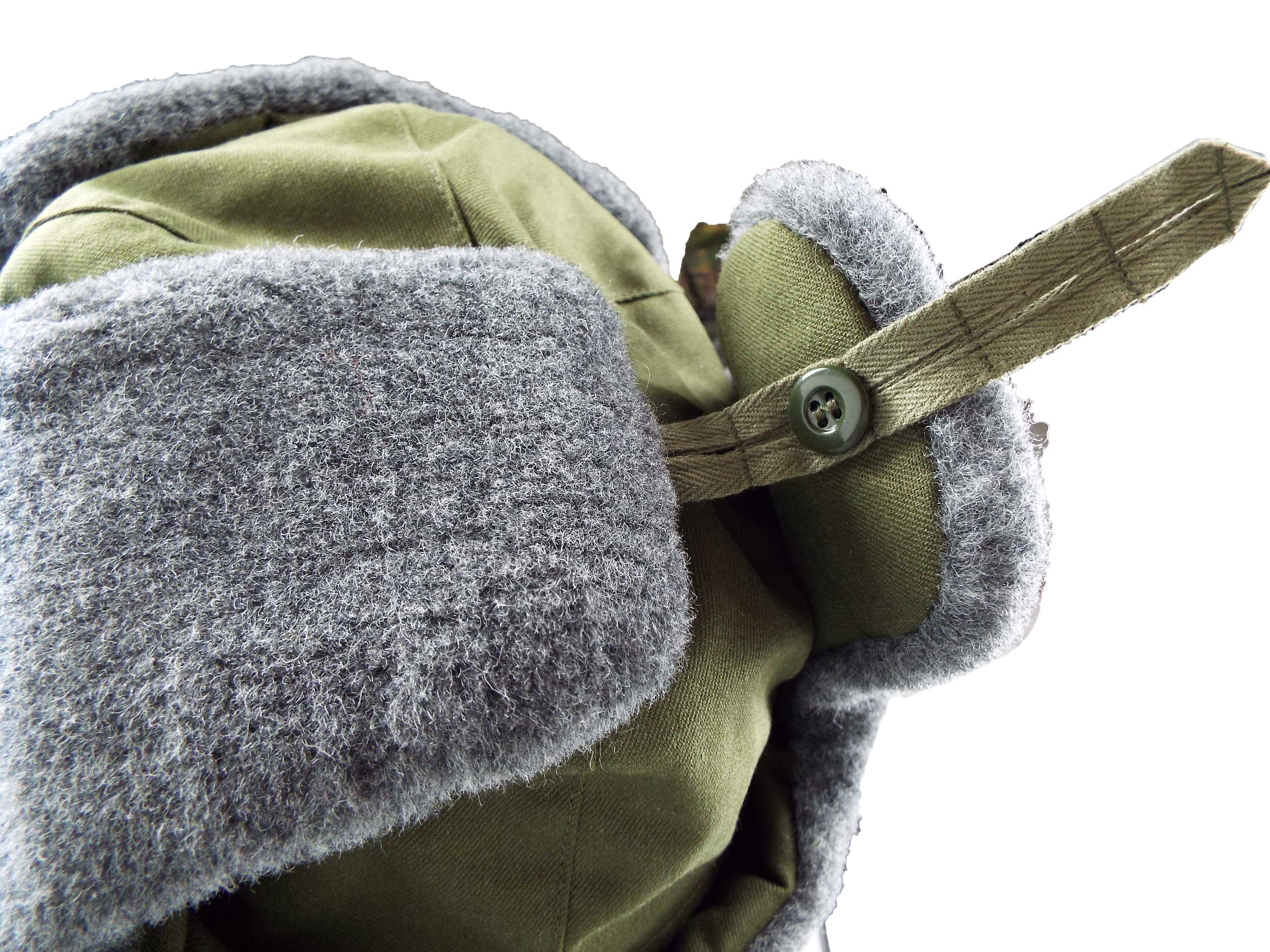 Close-up detail of the side button fastener used to secure the synthetic fur ear flaps of the Czech Army winter hat.