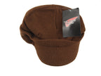 Top-down view of the brown Red Wing Shoes Radar beanie with the original brand hangtag still attached to the knit fabric.
