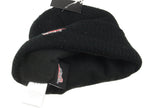 Close-up of the black beanie interior, showing the soft fleece lining, internal Red Wing branding label, and fabric care tag.