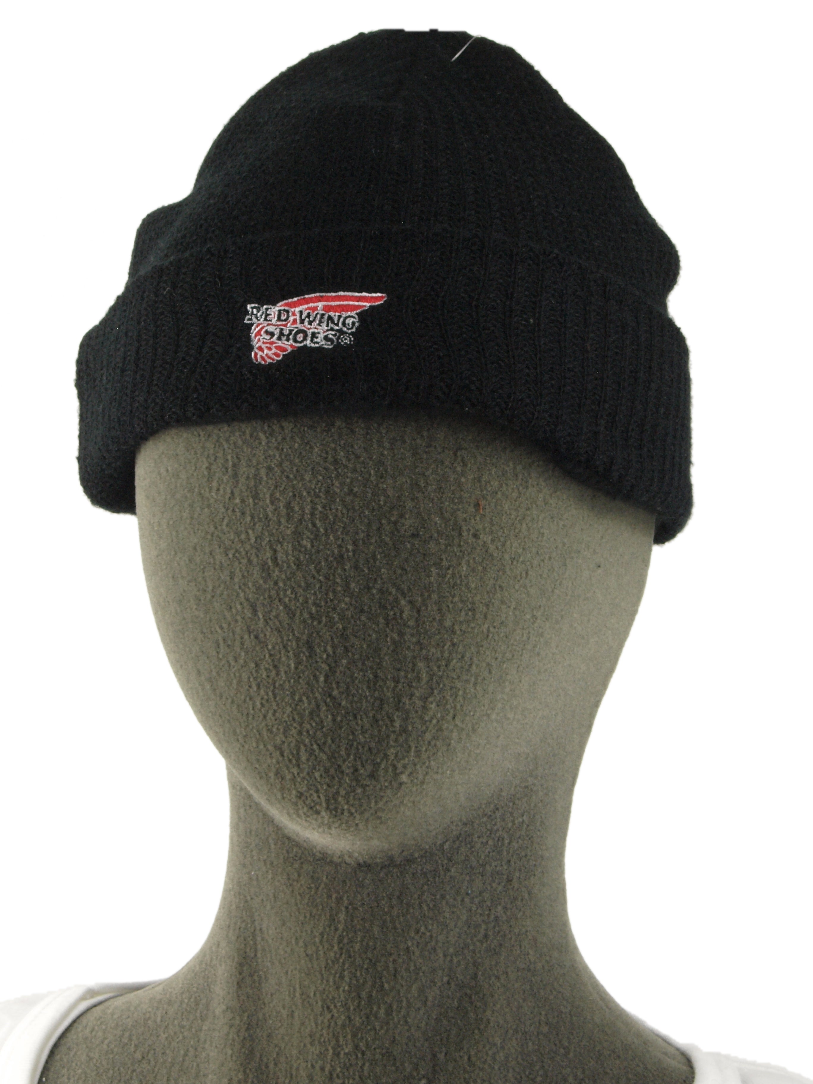 Front view of a black knit skull cap featuring the Red Wing Shoes logo, displayed on a grey mannequin head.