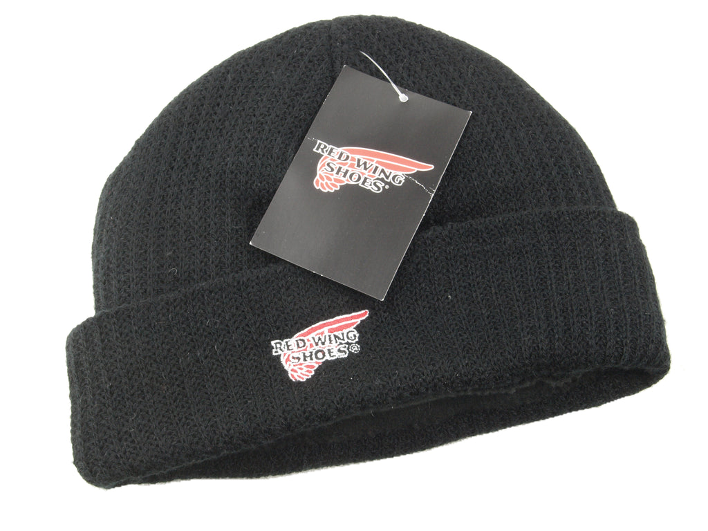 Black fleece-lined beanie hat folded flat, featuring an embroidered Red Wing Shoes logo and original brand tag attached.