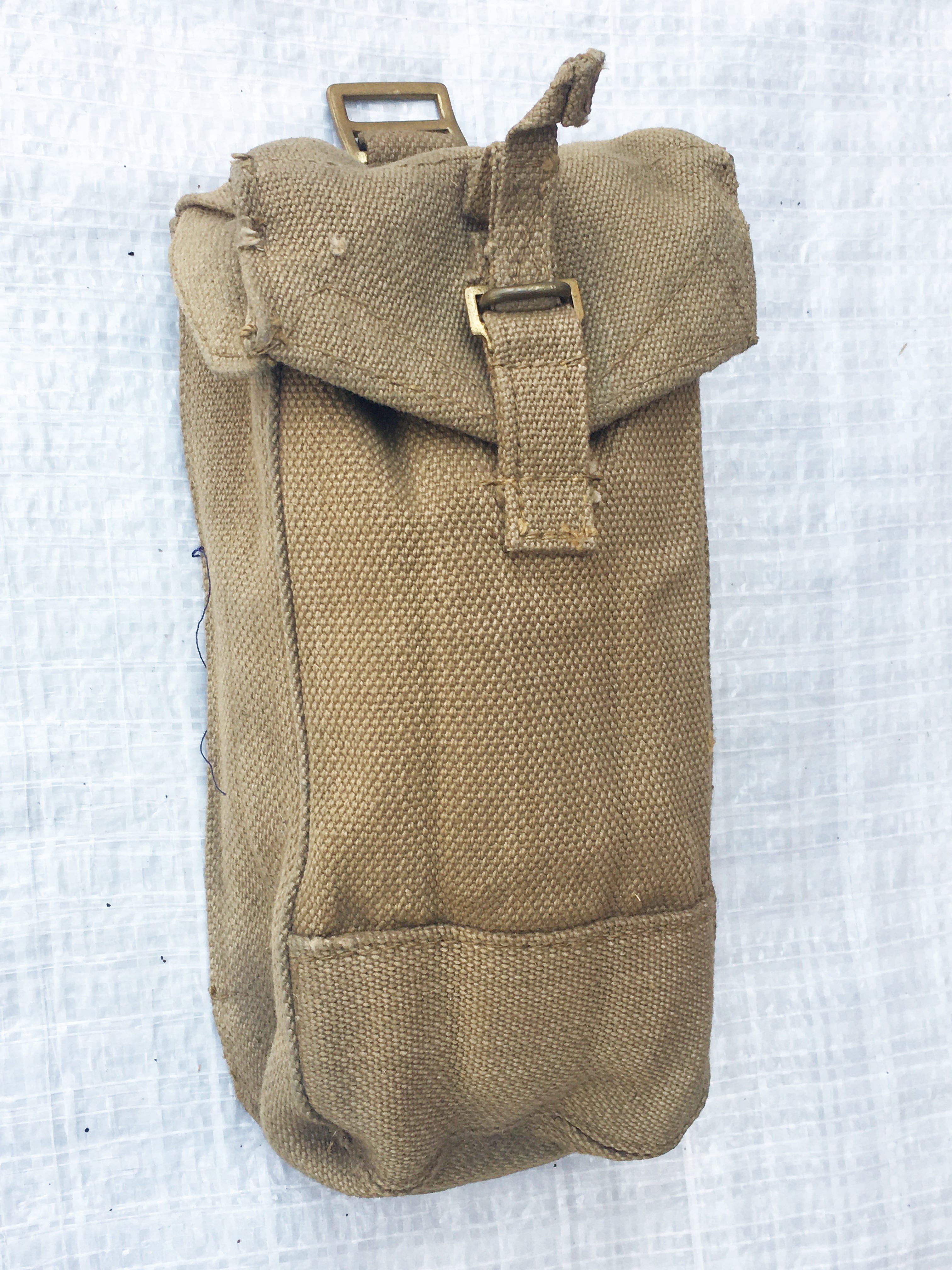Close-up front view of a khaki cotton canvas British Army Mark III ammo pouch with a secure press stud fastener.