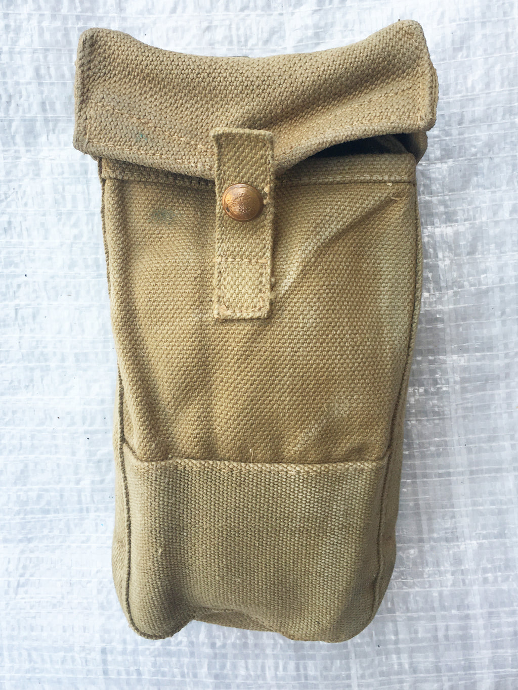 Front detail of a faded brown British Army Mark III ammo pouch featuring a sturdy press stud closure.