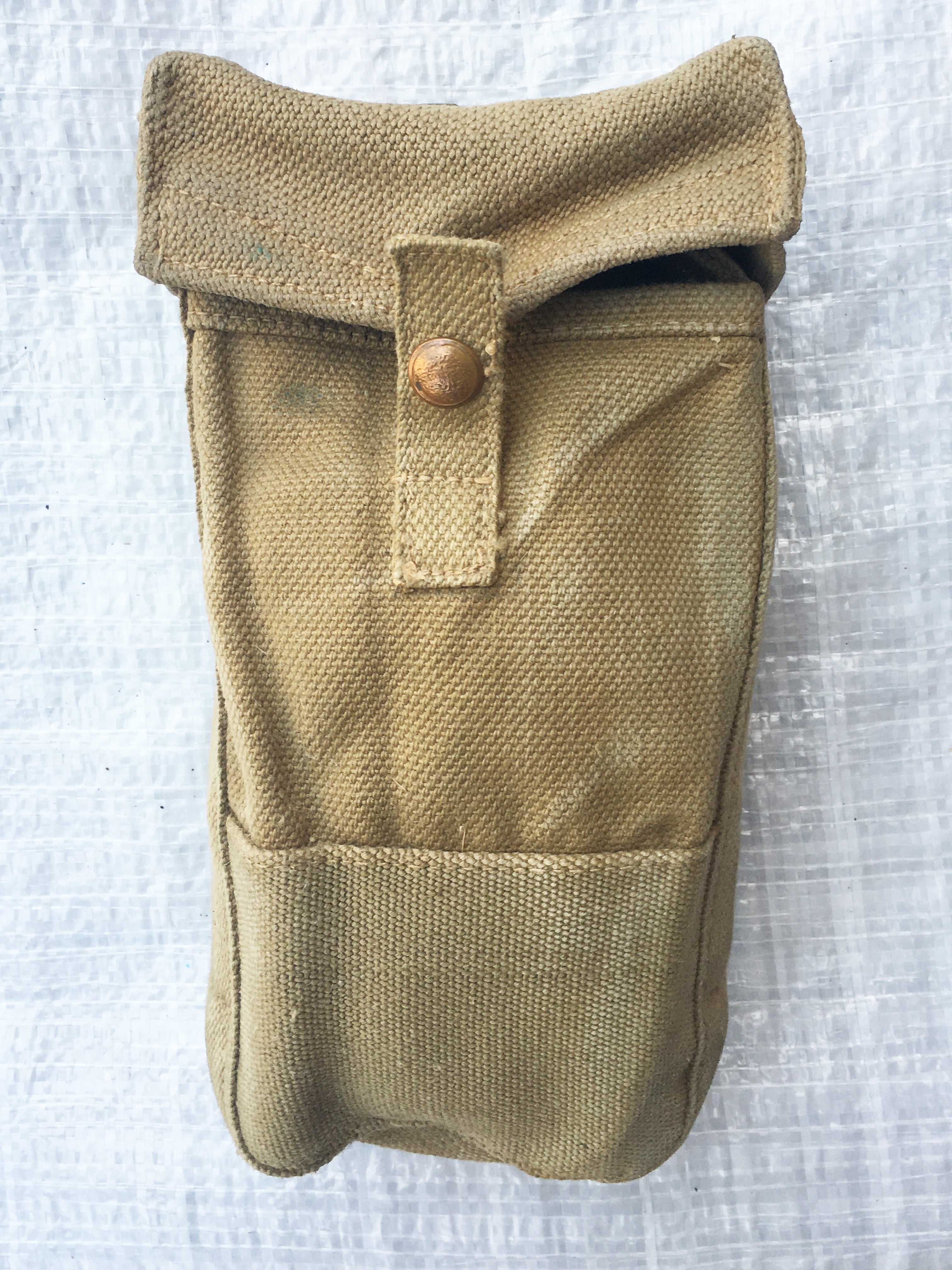 Front detail of a faded brown British Army Mark III ammo pouch featuring a sturdy press stud closure.