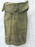 Close-up view of an olive drab WW2 Mark III ammo pouch showcasing the cotton canvas weave and brass press stud detail.