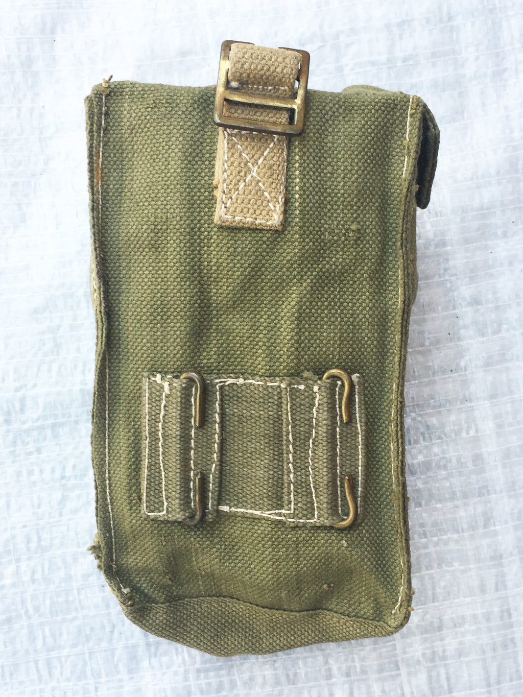 Rear view of an olive drab British Army Mark III ammo pouch showing the attachment loops for belt or webbing gear.