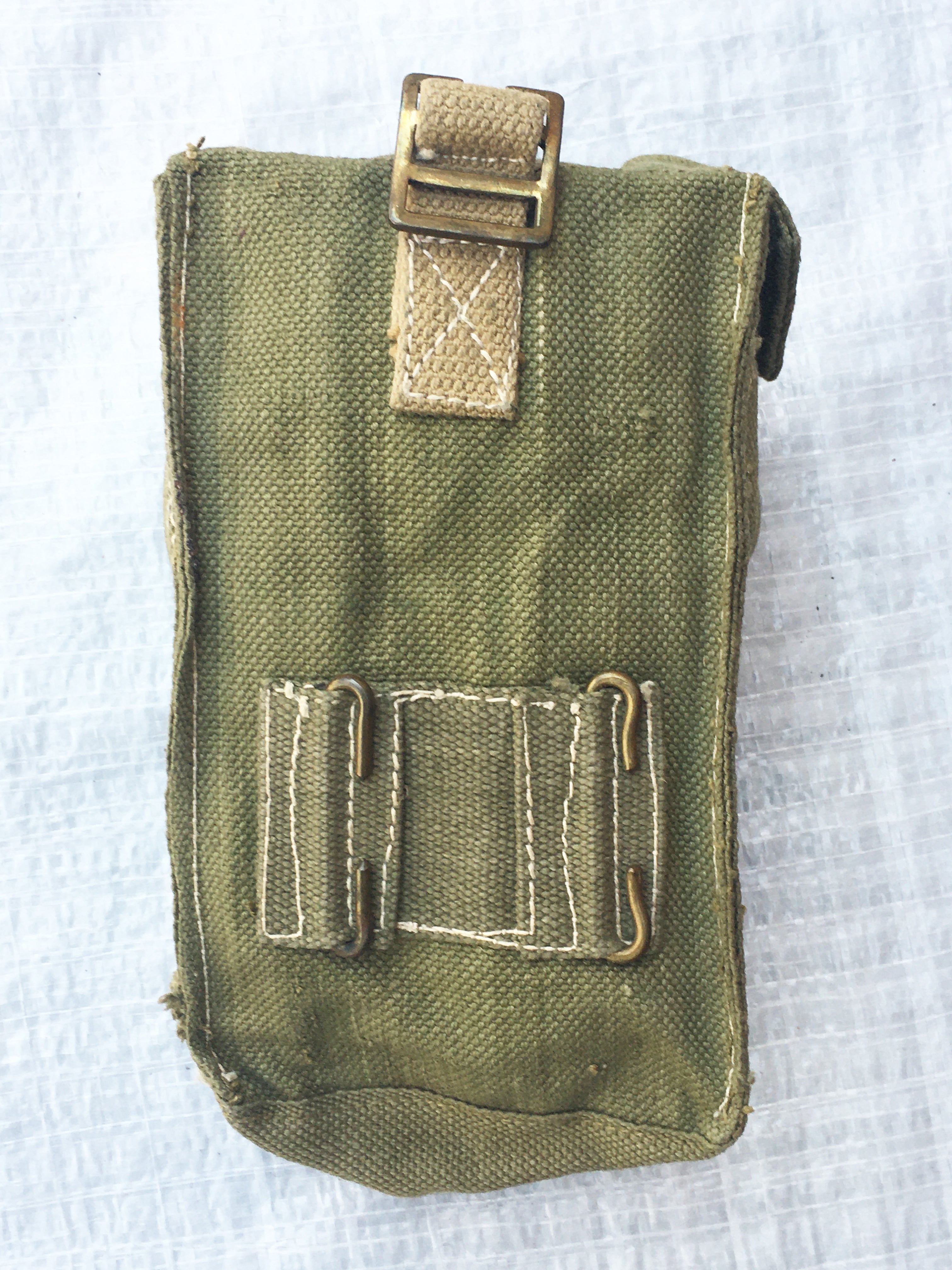 Rear view of an olive drab British Army Mark III ammo pouch showing the attachment loops for belt or webbing gear.