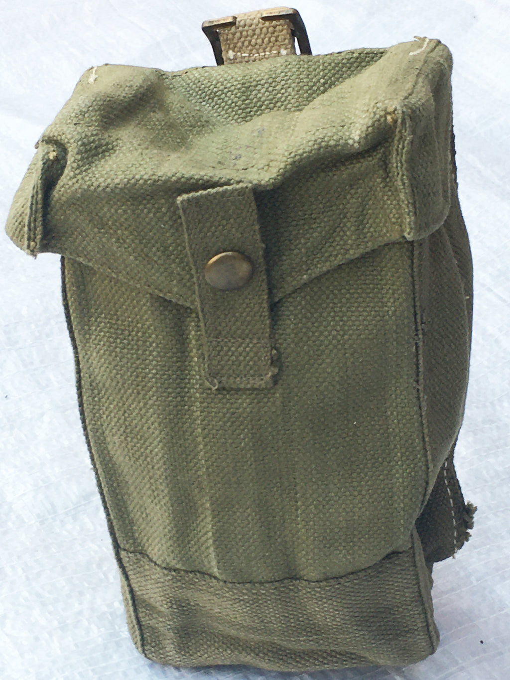 Side profile of a British Army Mark III ammo pouch in olive drab, highlighting the depth and durable construction of the surplus gear.
