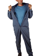 A person demonstrating the easy-access design of the RAF coveralls by unfastening the full-length front closure, revealing the durable build.