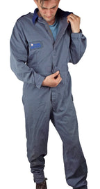 Close-up of a person adjusting the hook-and-loop front closure on a vintage British RAF jumpsuit with an embroidered chest patch.