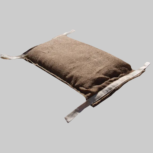 A single water-activated Dam It Up sandless flood bag made of textured jute with beige cotton handling tabs on each corner.