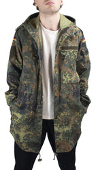 Detailed front view of the German military parka with hands in pockets, highlighting durable polycotton fabric.