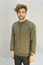 A model wearing a grey Swiss Army wool sweater with a zip-neck design and thick ribbed cuffs.